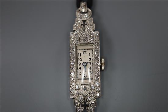 A ladys mid 20th century white metal (inscribed All Plat) and diamond set cocktail watch, on fabric strap.